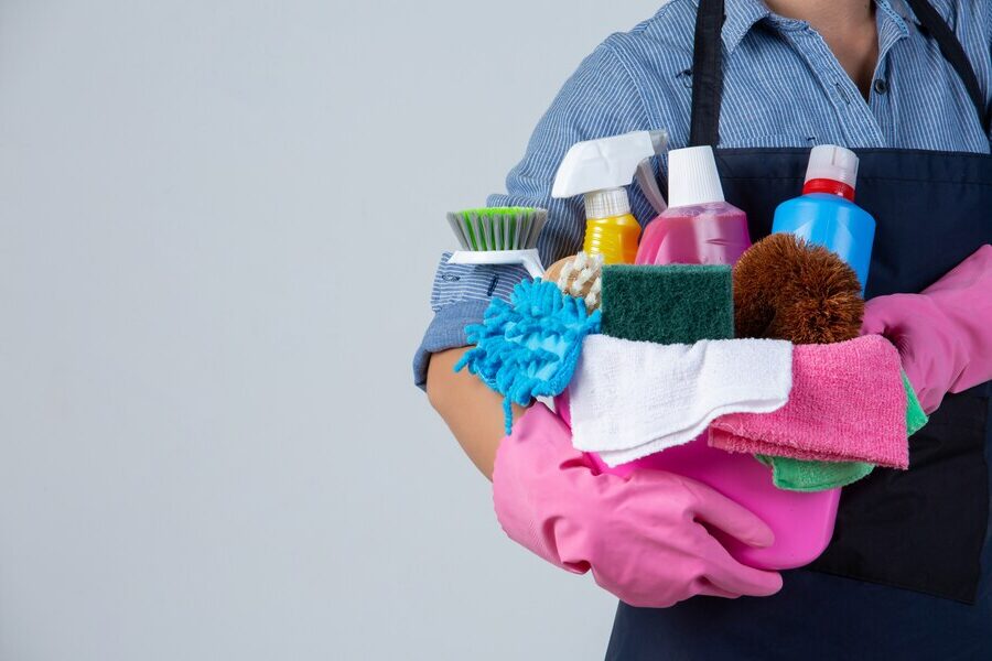 Professional cleaner using cleaning products to maintain a hygienic environment in Toronto