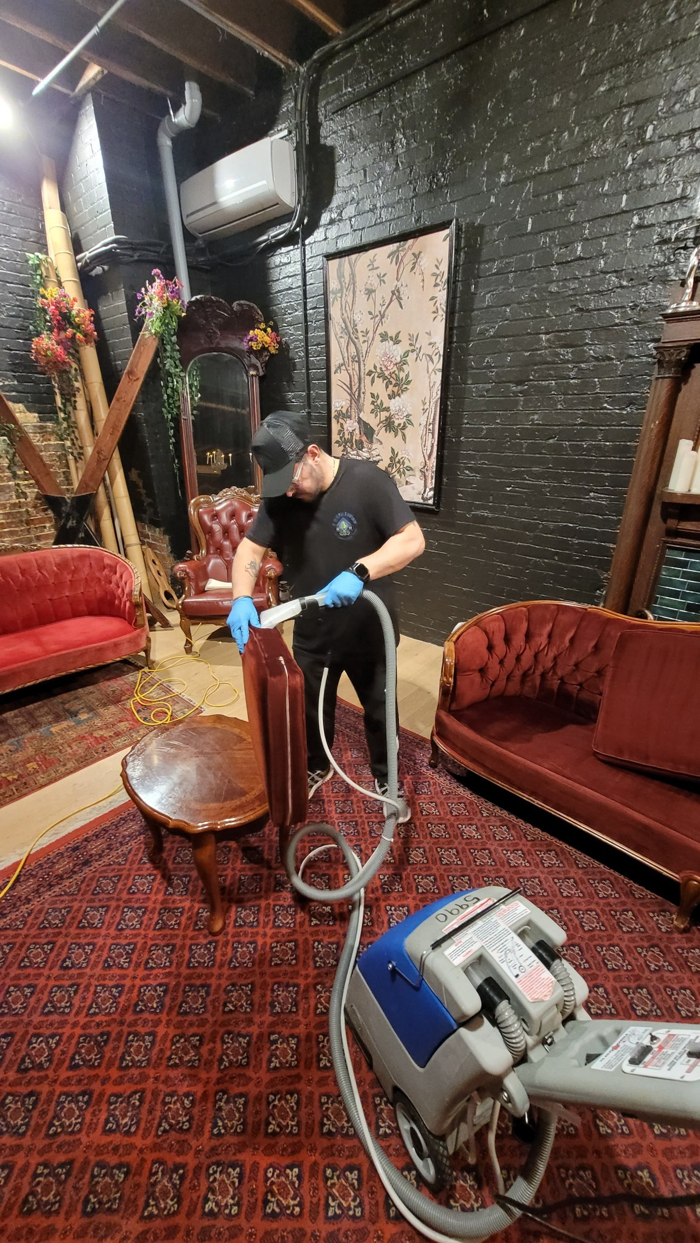 Professional commercial cleaning technician performing upholstery cleaning on furniture in a North York workspace