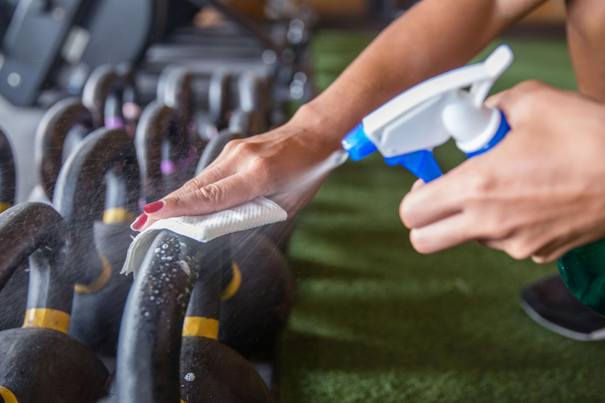 Cleaning gym equipment in a North York fitness facility to maintain a clean workout environment
